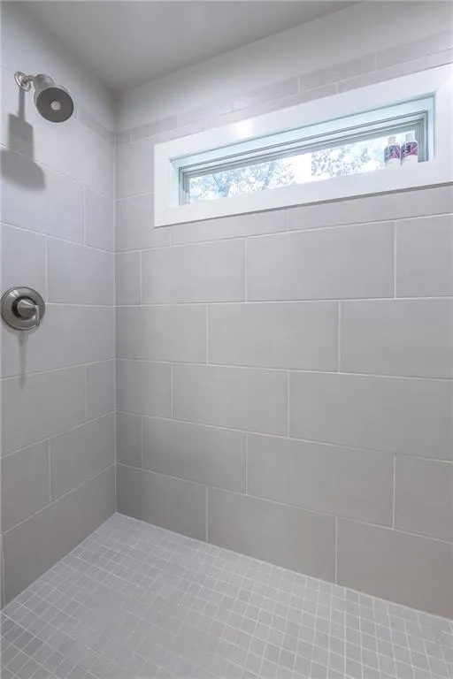 Bathroom featuring tiled shower