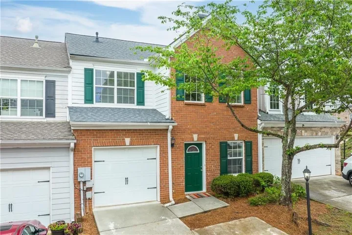 Brick and siding exterior with green accents
