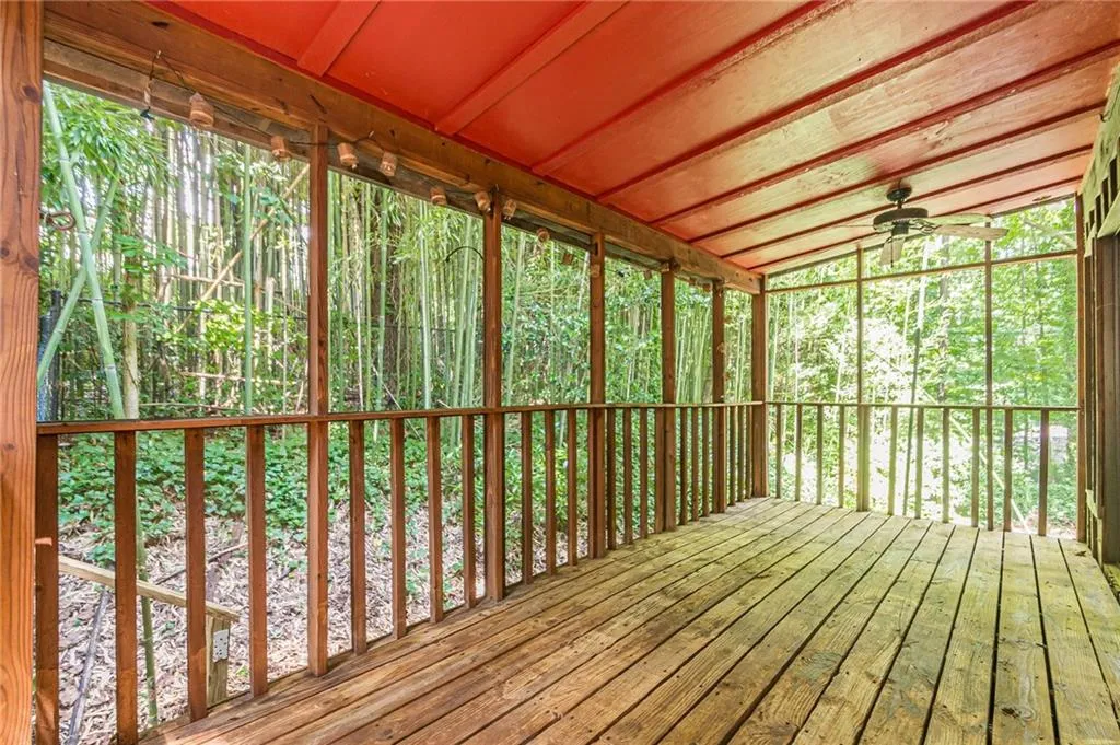 Unfurnished sunroom with ceiling fan and lofted ceiling