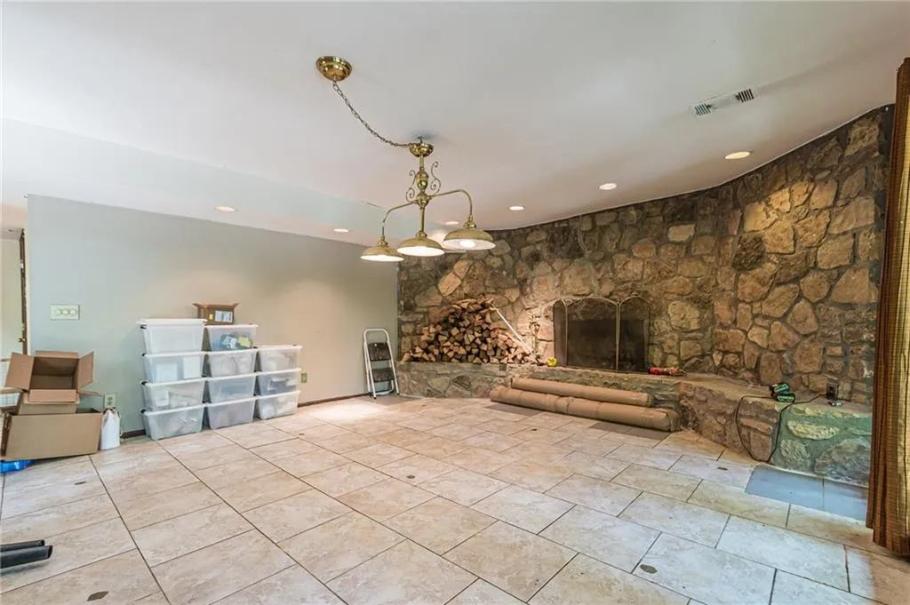 Unfurnished living room with a fireplace and light tile patterned floors