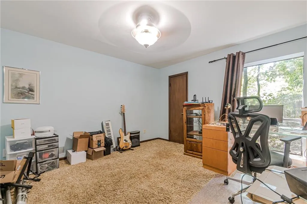 Office featuring ceiling fan and light colored carpet