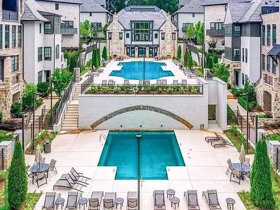 Pool featuring a residential view and a patio area