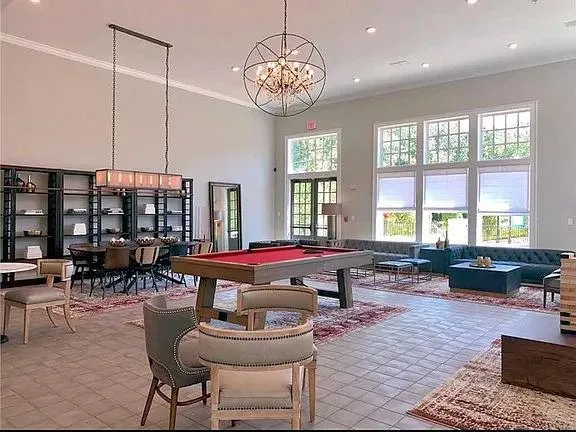 Rec room featuring crown molding, a high ceiling, a chandelier, recessed lighting, and billiards