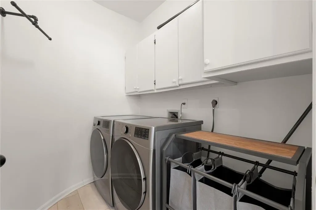 Laundry area featuring cabinet space and washer and dryer