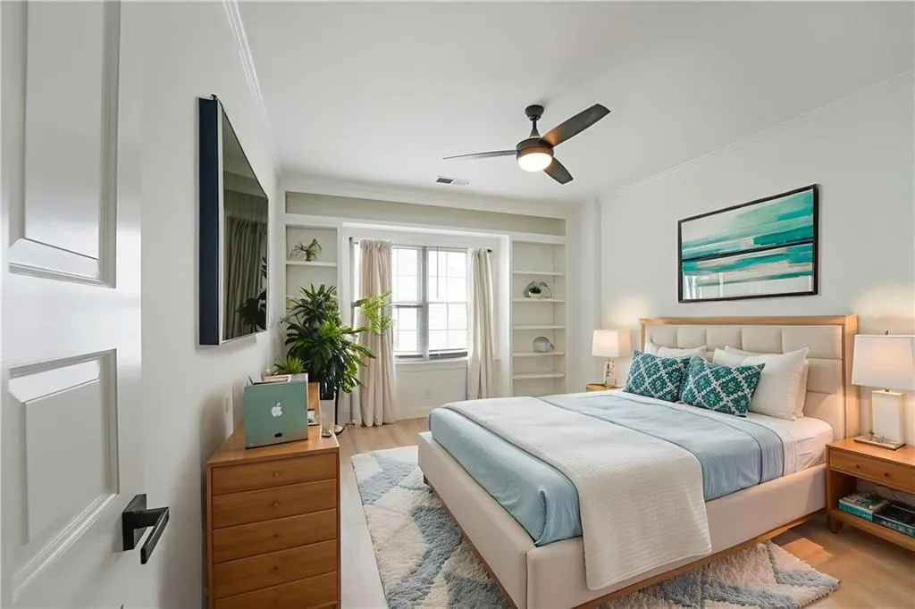 Bedroom featuring crown molding, wood finished floors, and ceiling fan