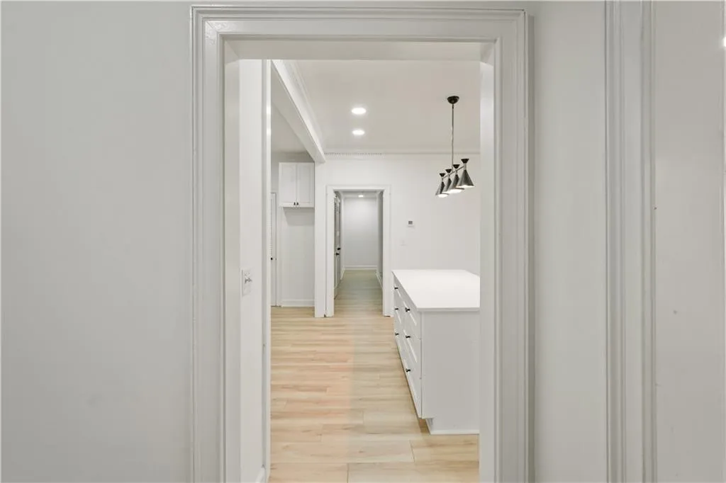 Hall featuring light wood-type flooring and recessed lighting