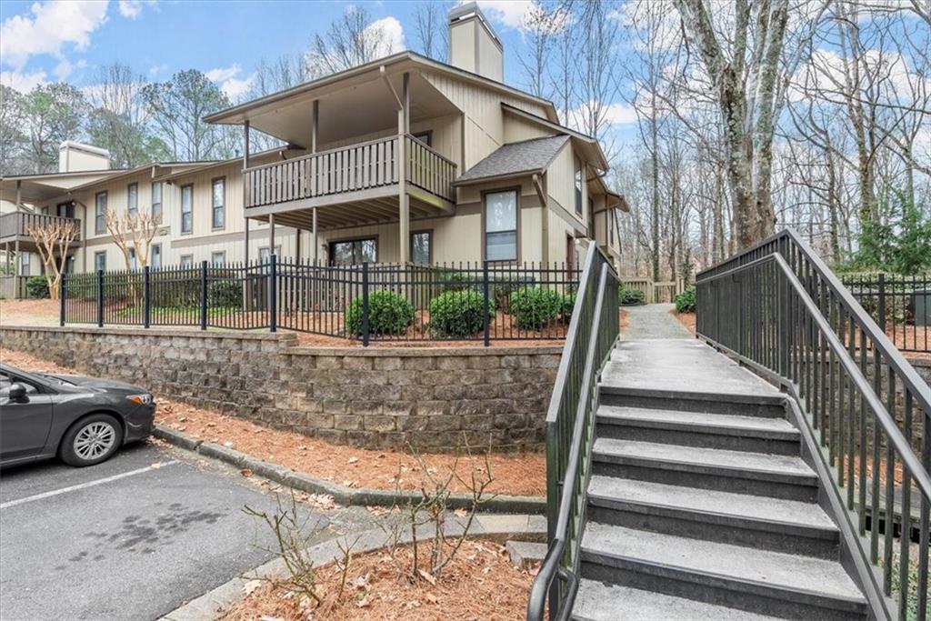 View of front of building with walkway to this unit