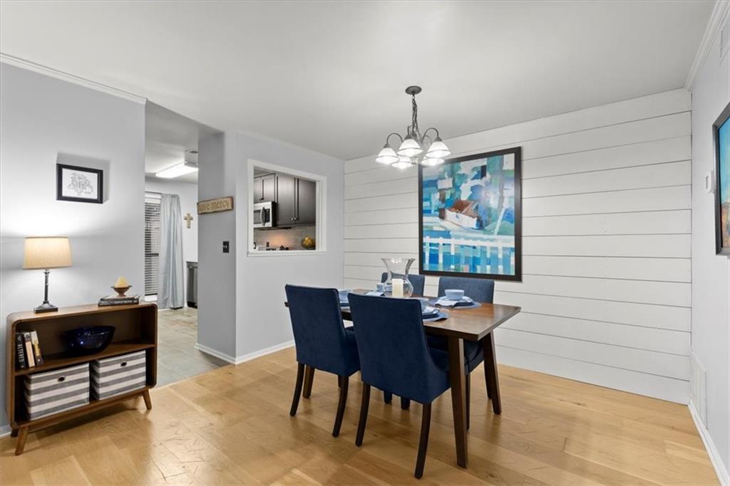 Dining space with an inviting chandelier and light hardwood floors