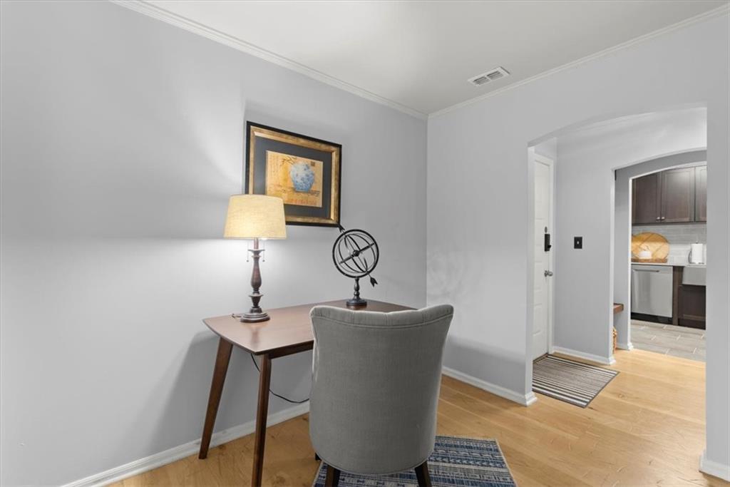 Office featuring light hardwood / wood-style flooring and crown molding