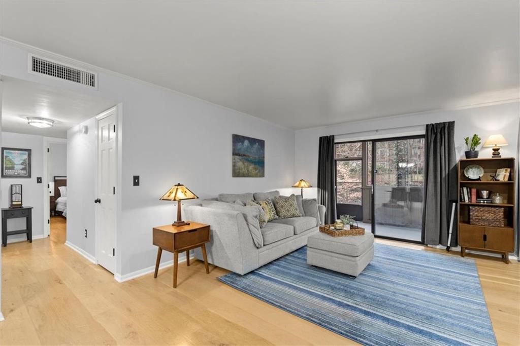 Living room with light hardwood / wood-style flooring