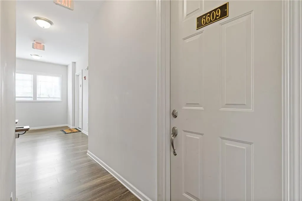 Hall with wood finished floors and baseboards