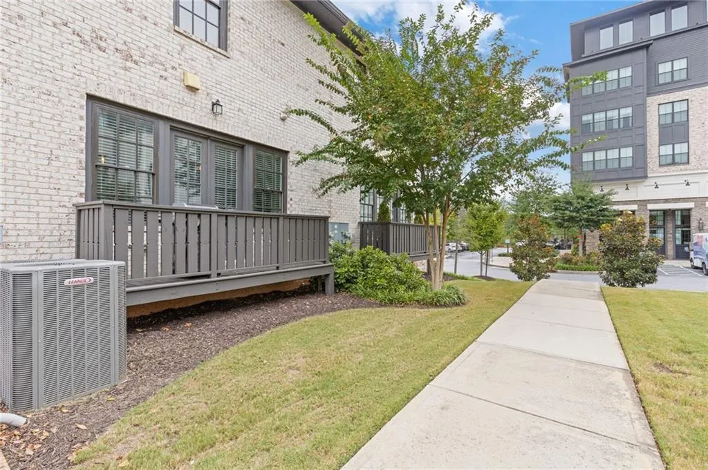 Surrounding community with a lawn and a deck