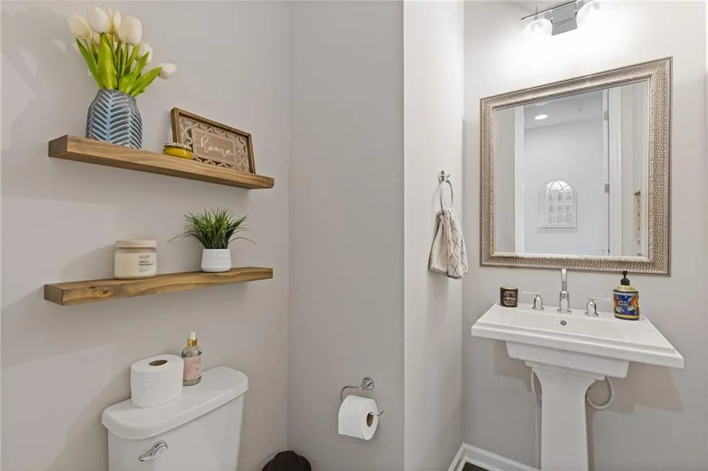 Half bathroom featuring toilet and a sink