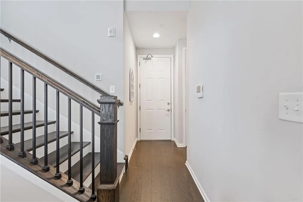 Hall featuring dark wood-style floors, stairway, and recessed lighting