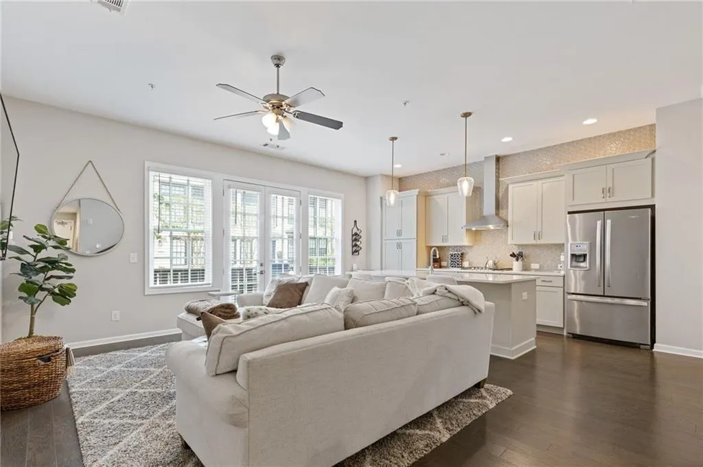 Living area featuring dark wood-style flooring, recessed lighting, and a ceiling fan