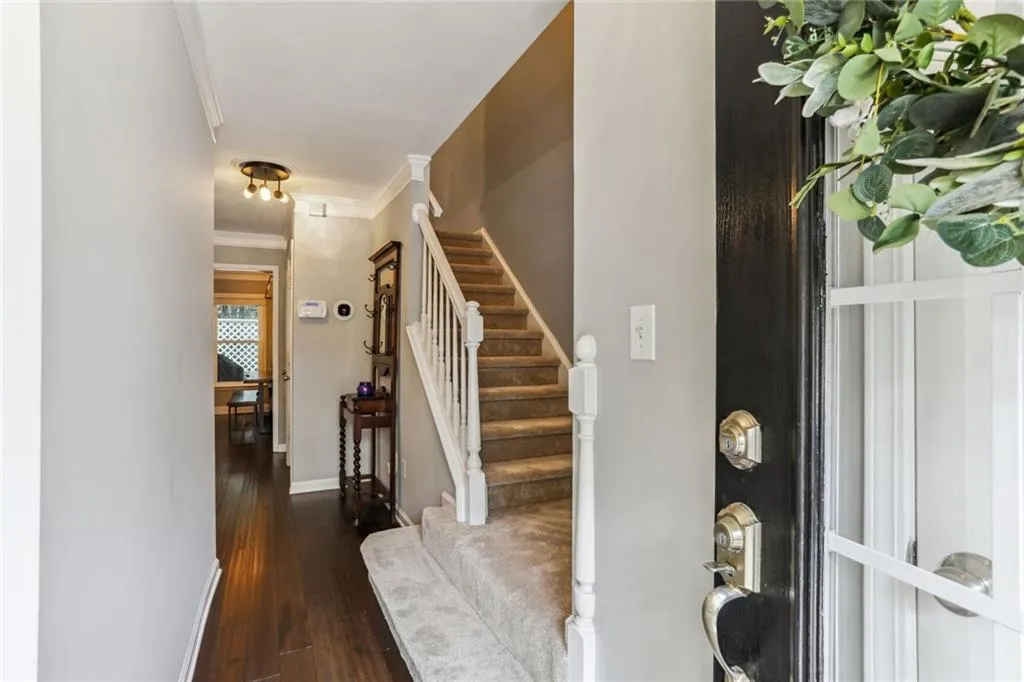 Entryway featuring ornamental molding and dark hardwood / wood-style flooring Entryway featuring ornamental molding and dark hardwood / wood-style flooring