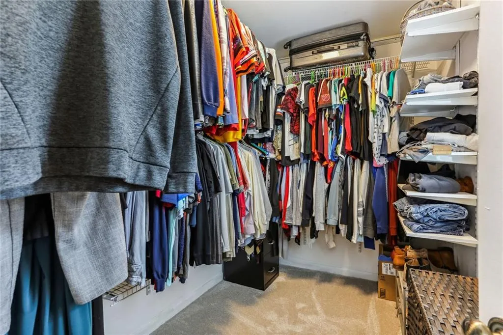 Walk in closet with carpet floors Walk in closet with carpet floors