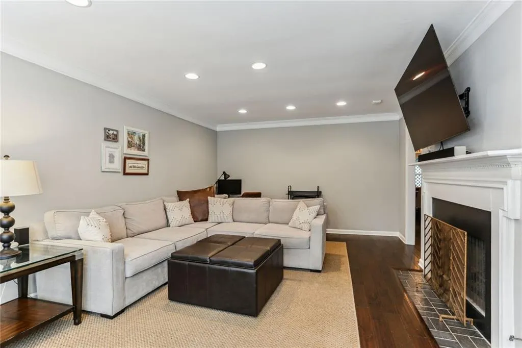 Living room with ornamental molding and hardwood / wood-style flooring Living room with ornamental molding and hardwood / wood-style flooring