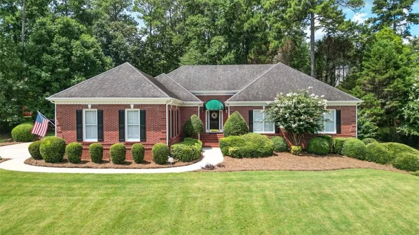 Brick exterior with a dark asphalt shingle roof