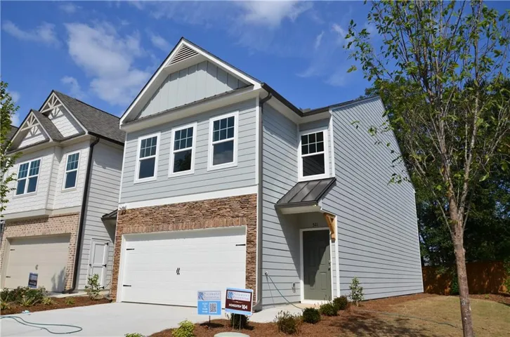 Two-story exterior with light blue horizontal siding and stone veneer accents