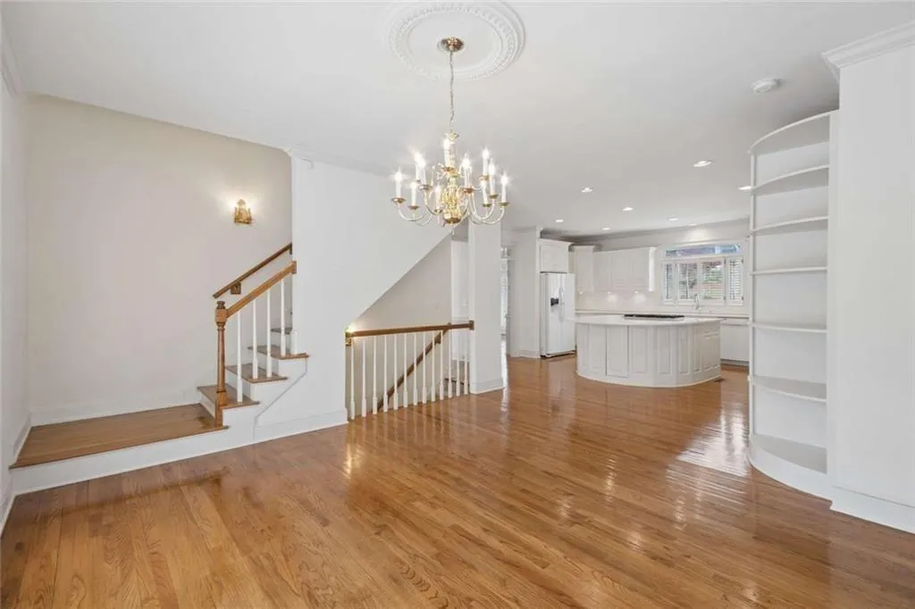 Large breakfast room, rear stairs up and stairs to full finished terrace level.