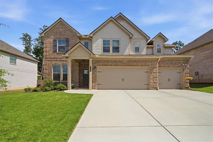 Brick and siding exterior featuring a covered entry