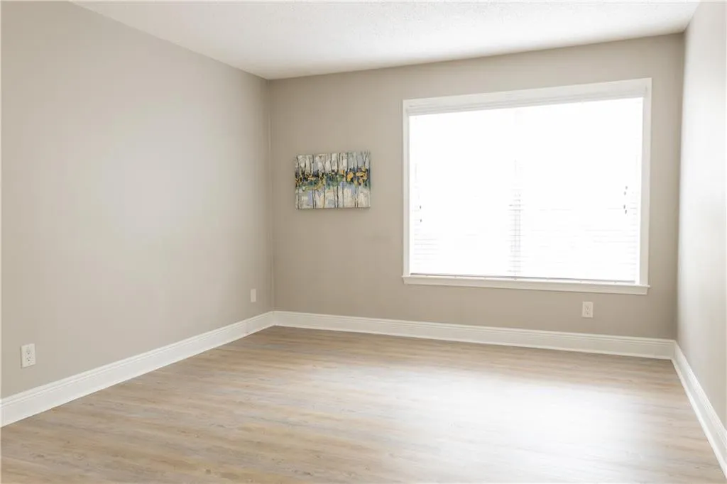 Empty room with light hardwood / wood-style floors