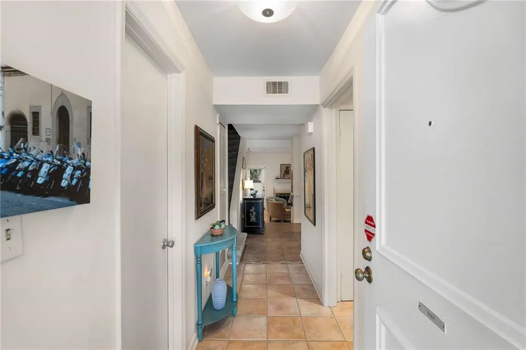 Entry way with hall perfect for lining the walls with all your art.  The half bath is located in this area as well.