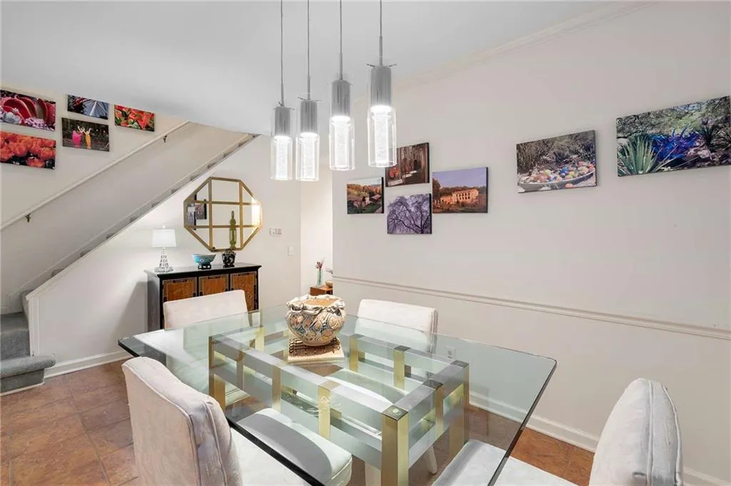 Dining area featuring baseboards, ornamental molding, and stairs