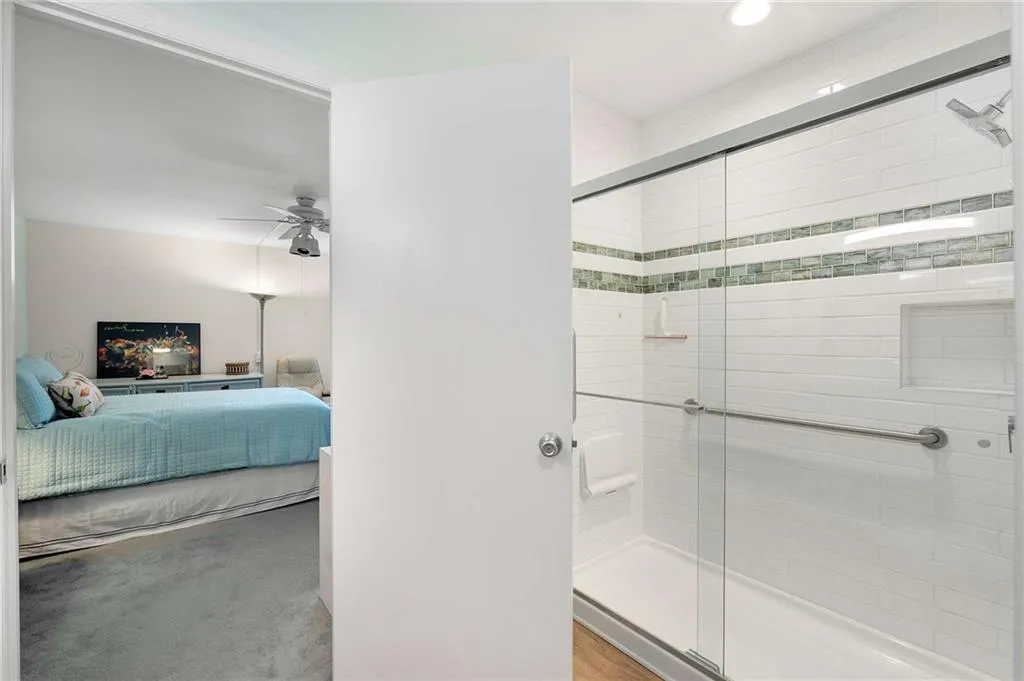 Ensuite bathroom with recessed lighting, ensuite bathroom, a ceiling fan, and a stall shower