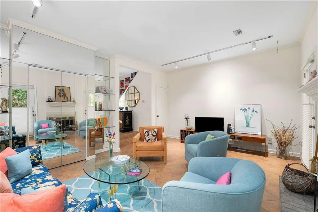 Living area featuring visible vents, rail lighting, and a fireplace