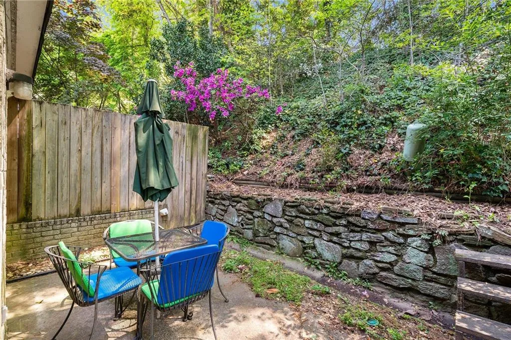 Back patio is wooded and private.  A perfect palate to plant flowers.