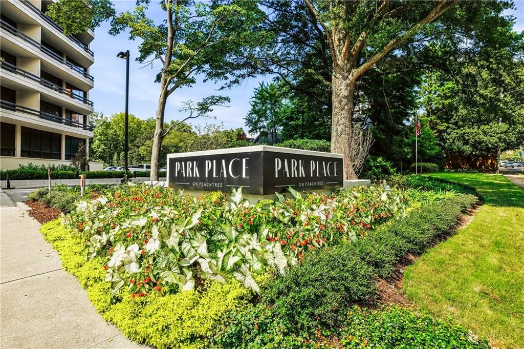 Entryway signage featuring "Park Place on Peachtree" lettering, surrounded by varied plantings
