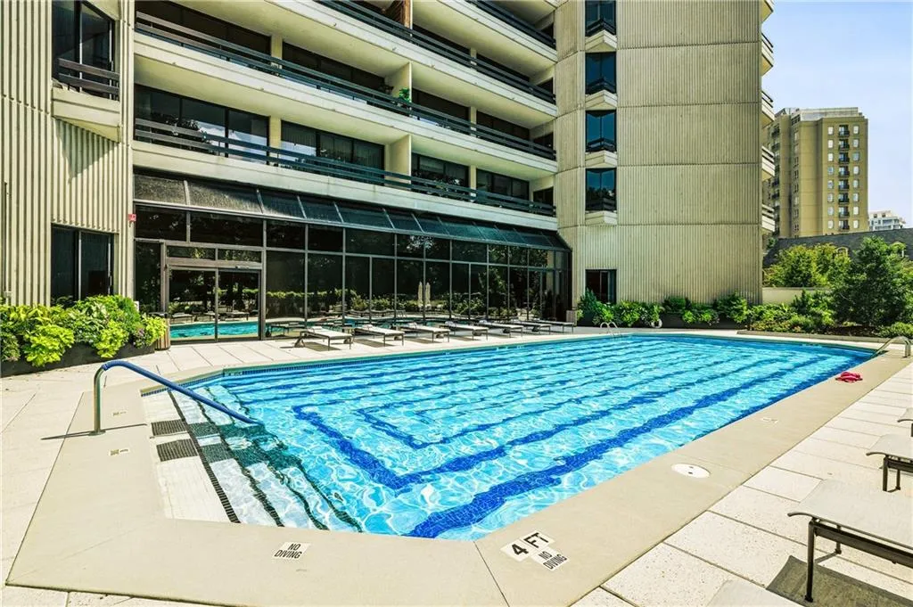 Outdoor swimming pool with integrated steps and blue tile accents