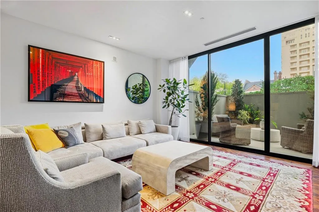 Hardwood flooring, recessed lighting, and expansive glass panel doors leading to a private outdoor space