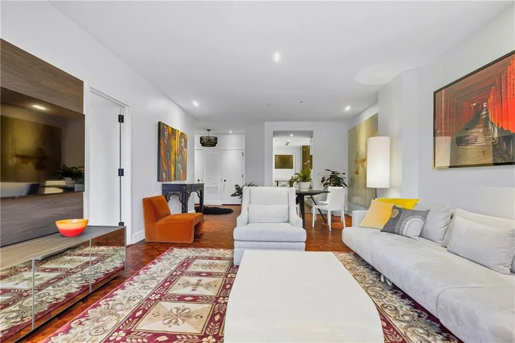 Recessed ceiling lighting, wood-finish flooring, and a built-in media console
