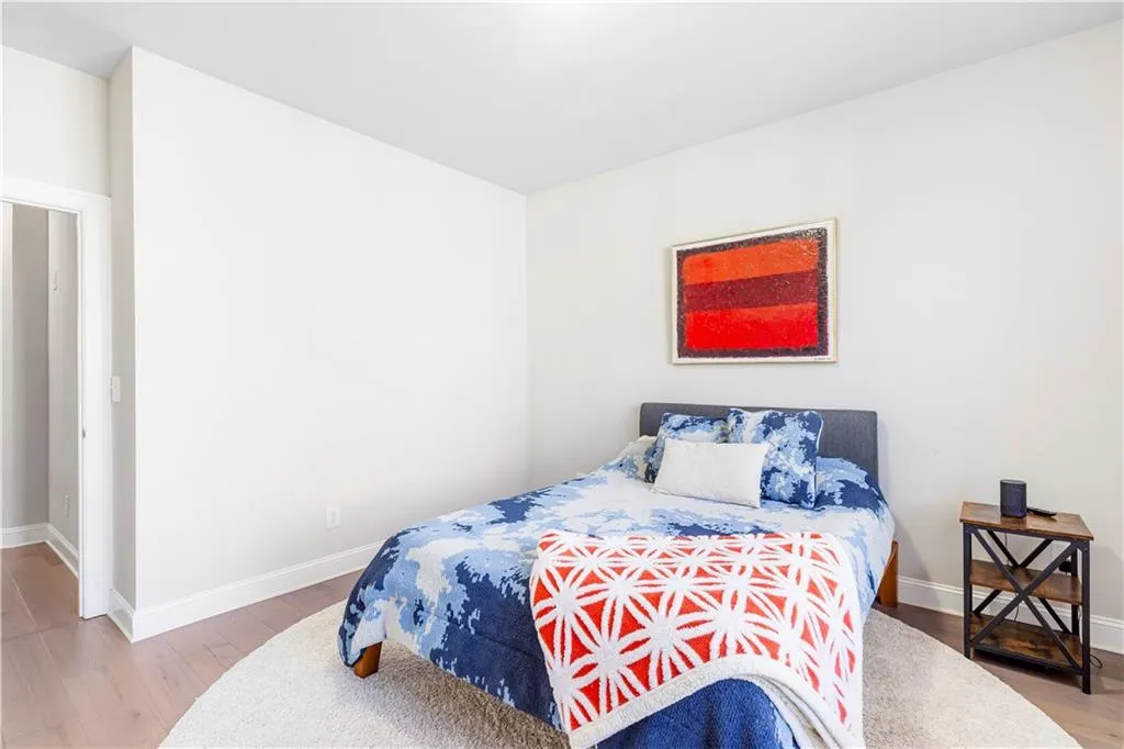 Bedroom with light wood-style floors and baseboards