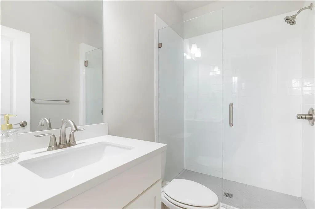 Full bathroom featuring vanity and a shower stall