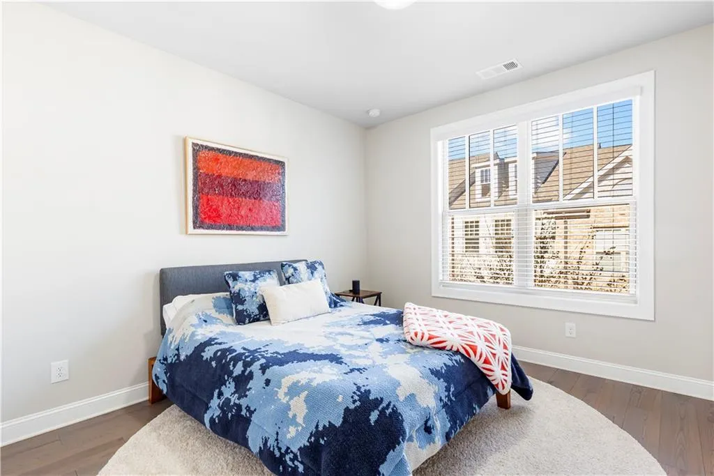 Bedroom with dark wood-style flooring