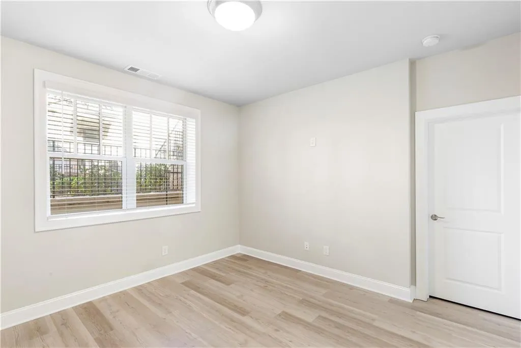 Empty room featuring baseboards and light wood-style floors