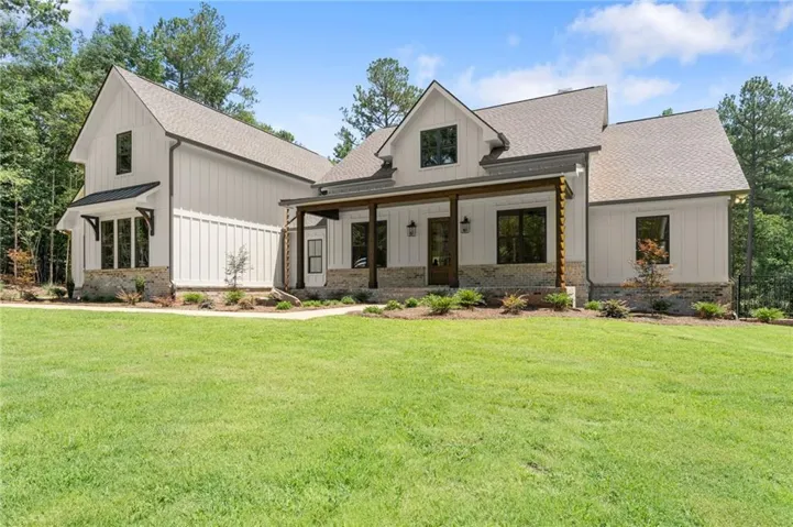 Contemporary farmhouse exterior with white board-and-batten siding