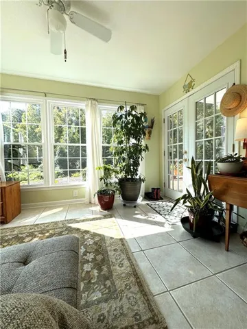 Tile flooring with light-colored walls and multiple window panes
