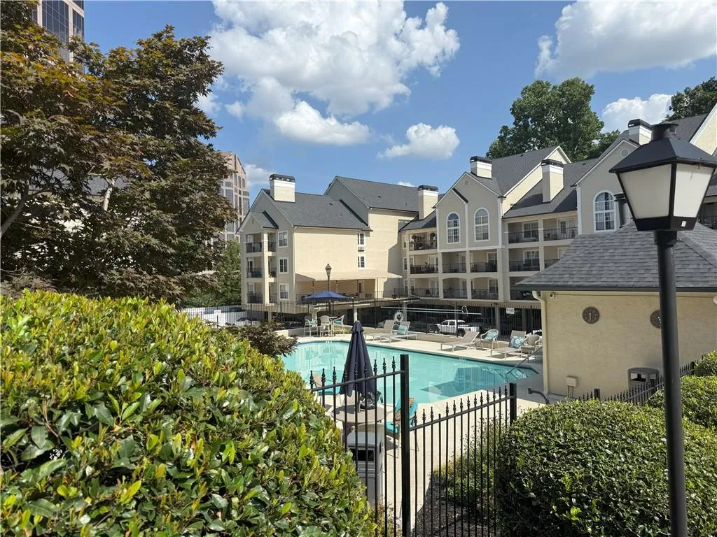 Community pool featuring a patio and a residential view