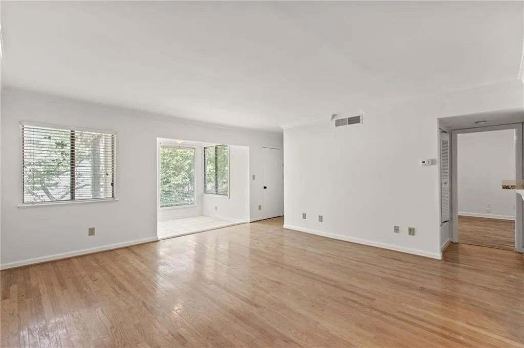 Unfurnished room featuring ornamental molding and light hardwood / wood-style flooring