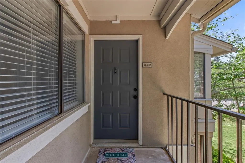 View of exterior entry featuring a balcony