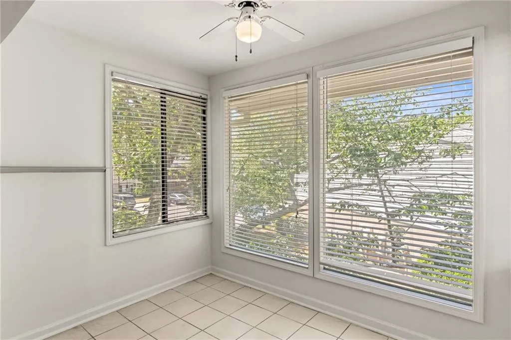 Tiled spare room with ceiling fan