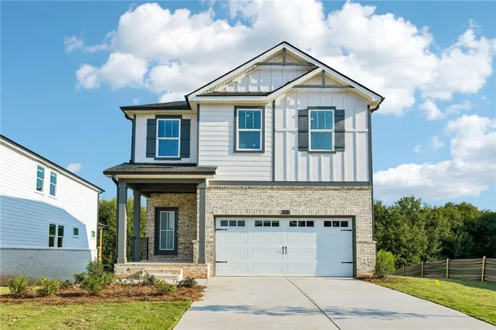 Two-story exterior with white siding and stone accents