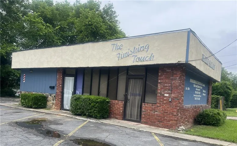 Commercial building featuring a stucco facade and brick lower exterior
