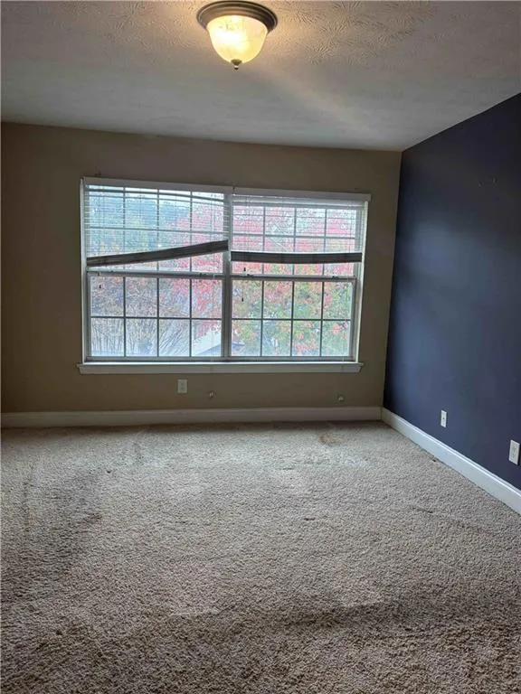 Carpeted bedroom featuring a textured ceiling Carpeted bedroom featuring a textured ceiling