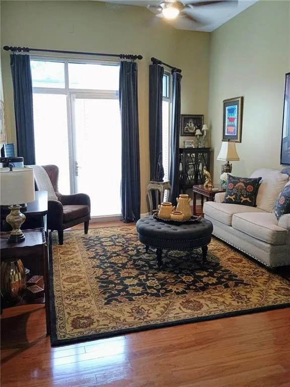 Living area with wood finished floors and ceiling fan
